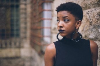 strong woman looking over shoulder trying to stay positive about her PMDD