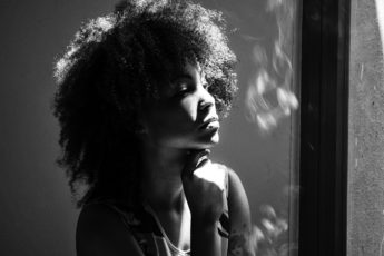 thoughtful woman looking away assessing risk of suicide with PMDD